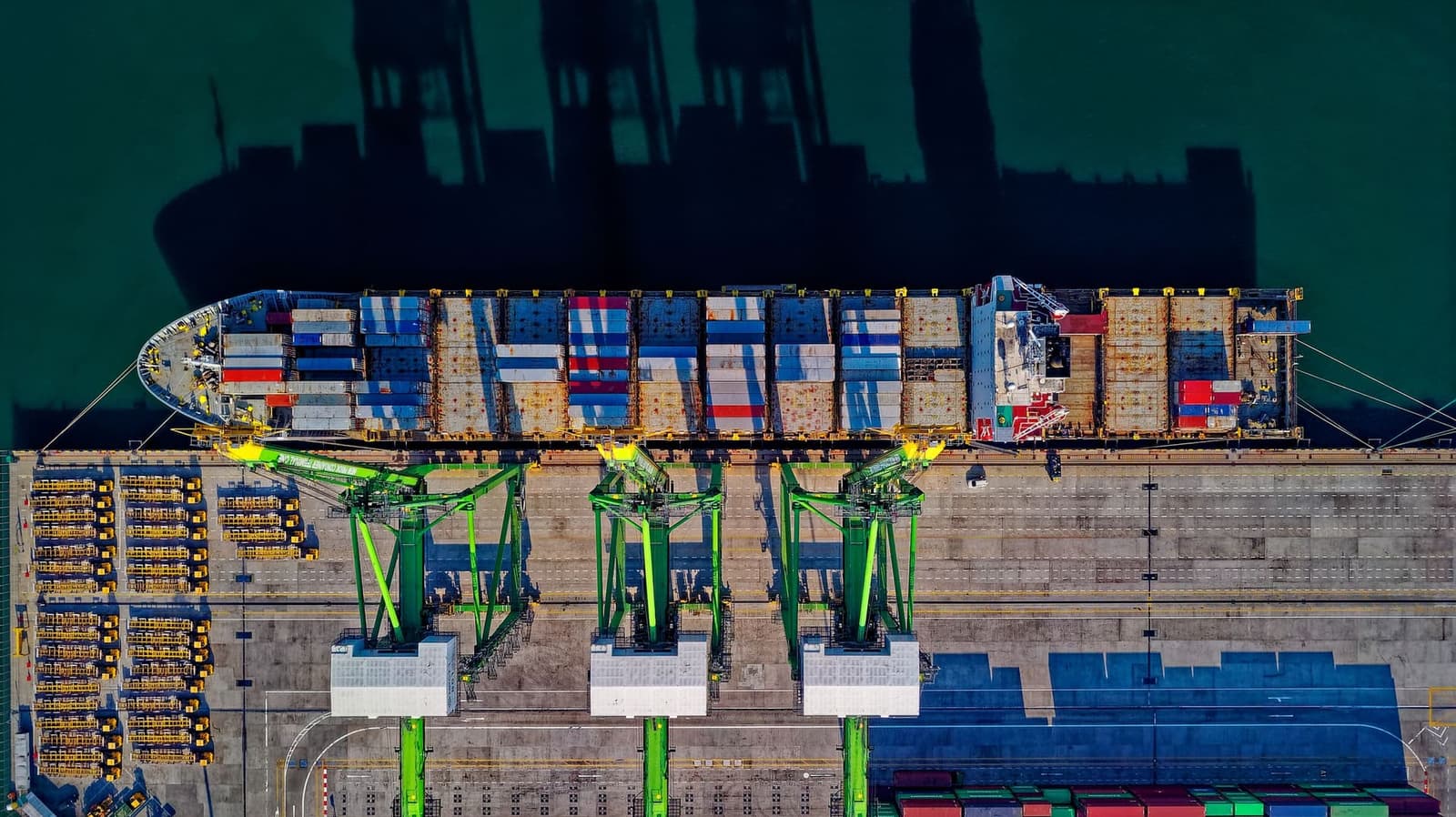Aerial view of a container ship at a busy shipping port